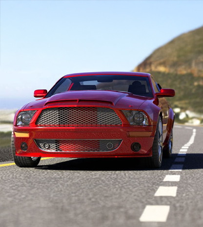 Red sports car driving on ocean-side road