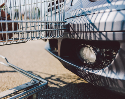 Shopping cart hitting parked car