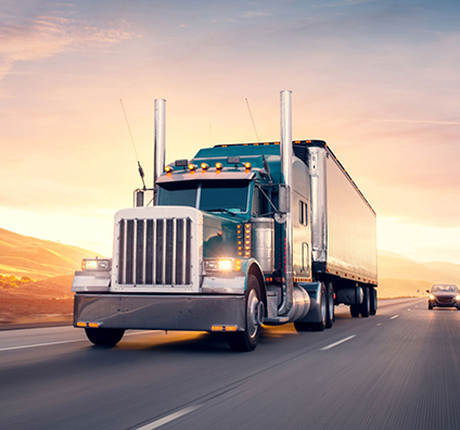 A heavy duty truck driving down a highway